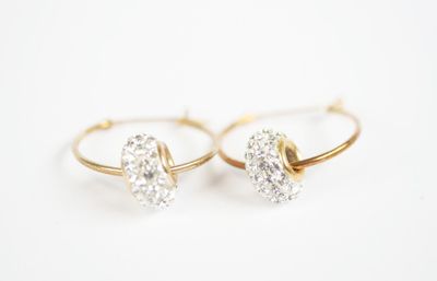 a pair of gold and diamond earrings on a white background