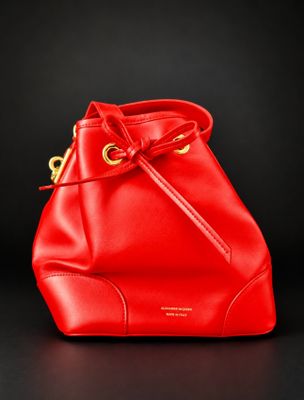 a red bucket bag on a black background