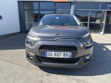 the front of a grey citrole parked in front of a building