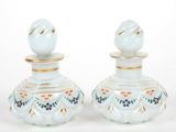 pair of white and gold vases with blue flowers on them