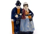 a figurine of a man and a woman sitting on a bench