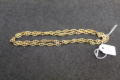 a close up of a gold chain with a tag on it