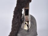 a silver helmet with a furry tail on top of it