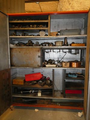 a metal cabinet with lots of tools in it