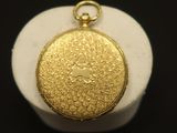 a close up of a gold locke on a black surface