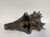 a bronze sculpture of a bird ' s head on a white surface