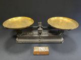 a pair of brass scales on a stand with a wooden box