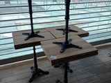 two wooden tables sitting on top of a wooden floor