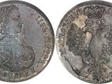 a close up of two silver coins on a white background