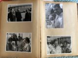 an open book with pictures of people on it on a bed