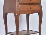 a small wooden table with a drawer on top of it
