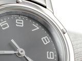 a close up of a watch on a white surface