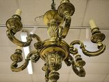 a gold chandelier hanging from the ceiling in a room
