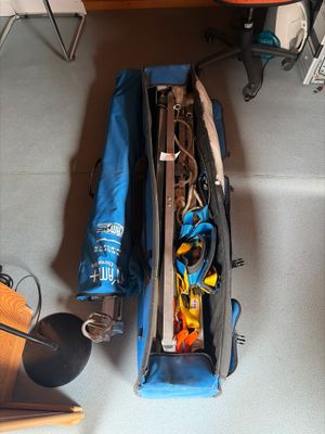 a blue bag filled with items sitting on the floor