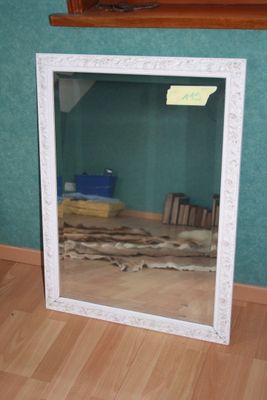 a mirror that is sitting on the floor in a room