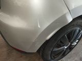 a close up of a car ' s bumper with a denting on it