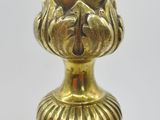 a gold vase that is sitting on a table