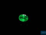 a green emerald gems on a black background