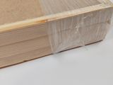 a close up of a book wrapped in plastic on a table