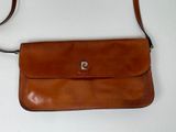 brown leather handbag with strap on white surface