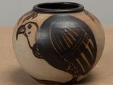 a black and white vase with a bird on it