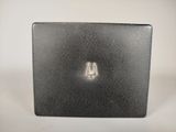 a small black box with a silver logo on it