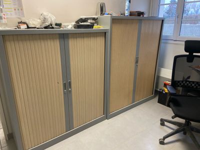a desk with a chair and a cabinet in a room