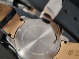 a close up of a watch on a black surface