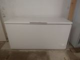 a white chest freezer sitting in the corner of a room