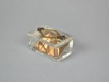 a small clear box with a pair of scissors inside of it