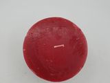 candle in the snow on a white surface with a red candle