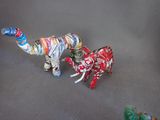 two toy animals made out of newspaper on a table
