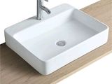 a white sink sitting on top of a wooden counter