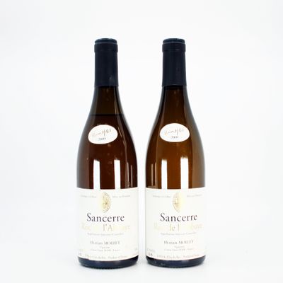 two bottles of white wine sitting next to each other on a white surface