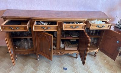 a wooden cabinet with two drawers and a door open
