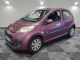 a picture of a small purple car parked in a garage