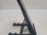 a black tablet on a stand on a white surface