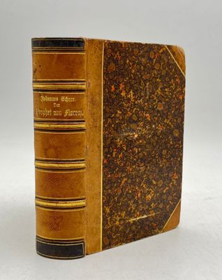 an old book with a brown cover sitting on top of a table