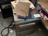 a pile of papers sitting on top of a metal counter
