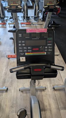 an image of a row of stationary exercise bikes in a gym