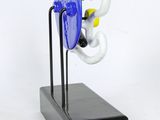 a blue and white object on a black stand