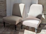 two chairs sitting next to each other on a tiled floor