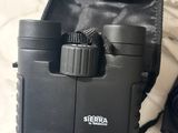 a close up of a pair of binoculars on a bed