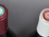 two bottles of wine sitting next to each other on a table