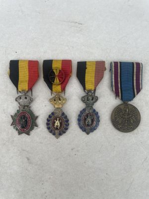 three medals and a medal are sitting on a white surface