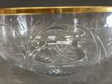 a glass bowl with a gold rim sitting on a table