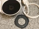a camera that is sitting on the floor next to a charger