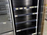 an empty refrigerator in the middle of a store