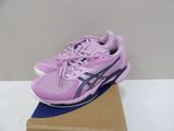 purple asics running shoes on a cardboard box on a table
