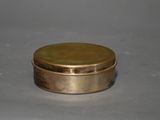 an image of a small brass box with a lid on a table